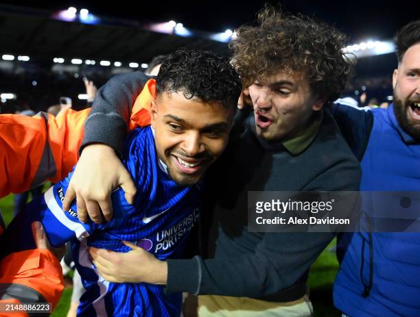 Tino Anjorin of Portsmouth celebrates with fans after becoming League One Champions during the Sky Bet League One match between Portsmouth and...
