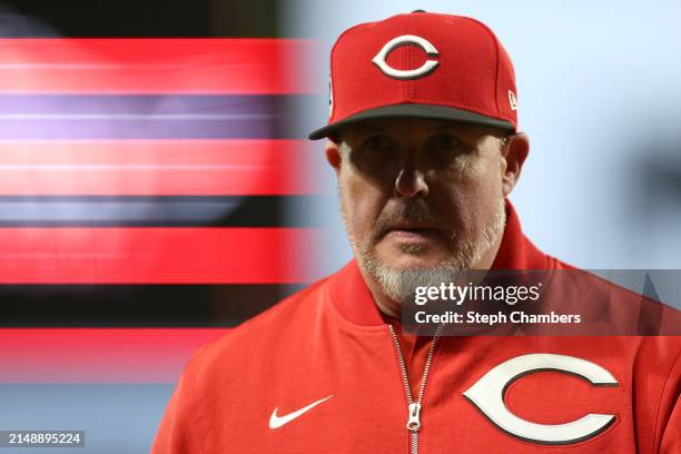 Pitching coach Derek Johnson of the Cincinnati Reds walks back to the dugout after a mound visit during the first inning against the Seattle Mariners...