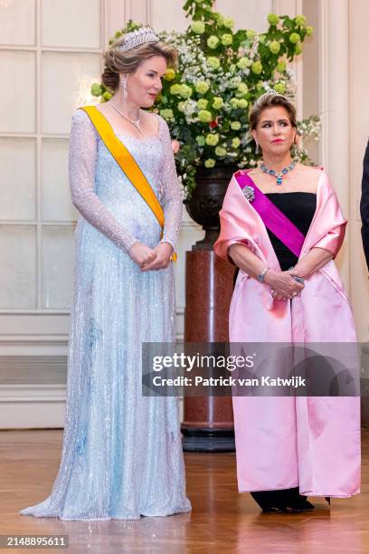 Queen Mathilde of Belgium and Grand Duchess Maria Teresa of Luxembourg attend the state banquet at the Laken Castle on April 16, 2024 in Brussels,...