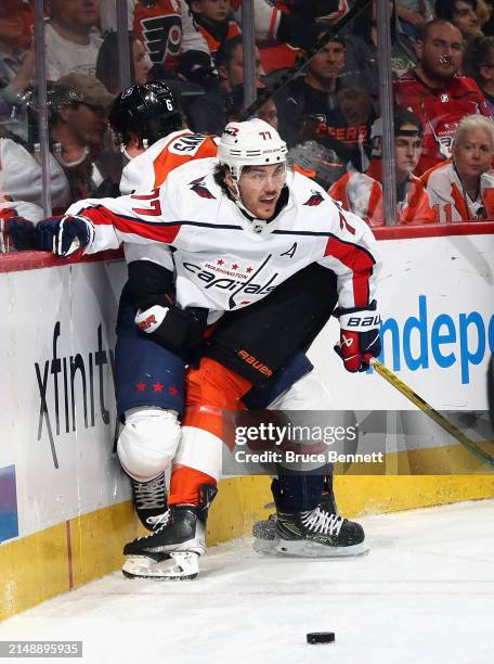 Travis Sanheim of the Philadelphia Flyers pins T.J. Oshie of the Washington Capitals to the boards during the first period at the Wells Fargo Center...