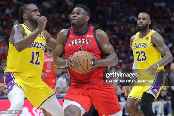 Zion Williamson of the New Orleans Pelicans drives against Taurean Prince and LeBron James of the Los Angeles Lakers during the first half of a game...