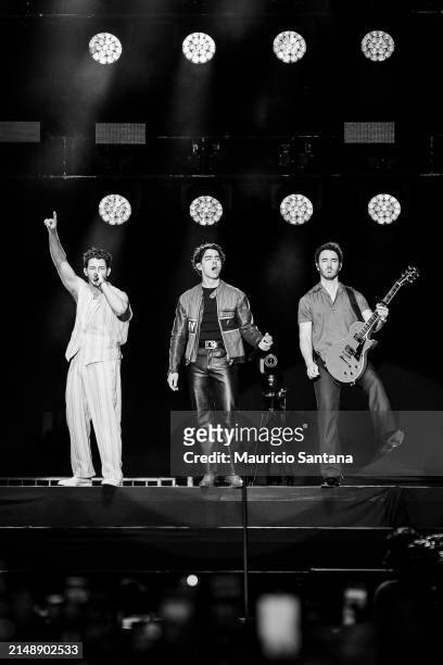 Nick Jonas, Joe Jonas and Kevin Jonas of Jonas Brothers perform live on stage during a concert on April 16, 2024 in Sao Paulo, Brazil.