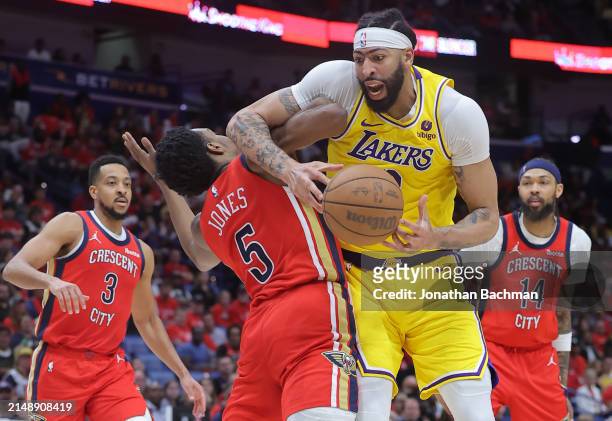 Anthony Davis of the Los Angeles Lakers is fouled by Herbert Jones of the New Orleans Pelicans during the second half of a play-in tournament game at...