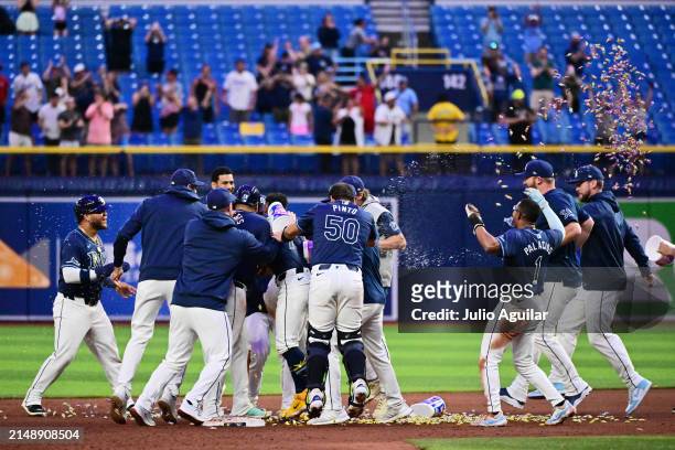 The Tampa Bay Rays celebrate after defeating the Los Angeles Angels 7-6 on a walk-off single off the bat of Amed Rosario in the 13th inning at...