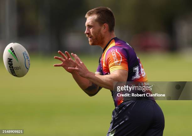 Cameron Munster of the Storm takes the ball during a Melbourne Storm NRL training session at Gosch's Paddock on April 17, 2024 in Melbourne,...