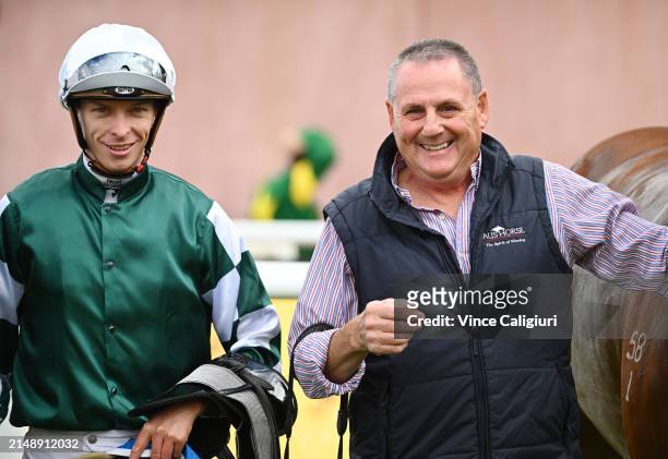 Michael Dee poses with trainer Grahame Begg after riding Rich Dottie after winning race 1, the Sportsbet Fast Form Handicap during Melbourne Racing...