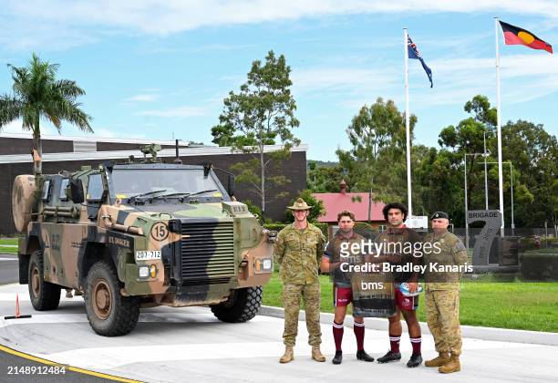 James O'Connor and Zane Nonggorr pose for a photo with soldiers from 3RAR during the unveiling of the Queensland Reds 2024 ANZAC jersey at Enoggera...