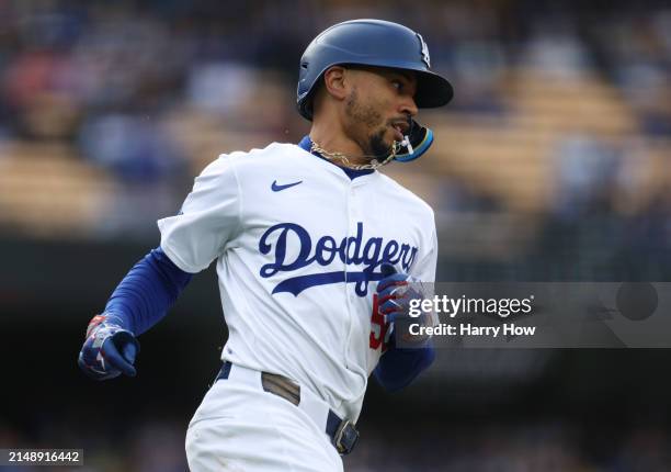 Mookie Betts of the Los Angeles Dodgers runs to first during a 6-3 loss to the San Diego Padres at Dodger Stadium on April 14, 2024 in Los Angeles,...