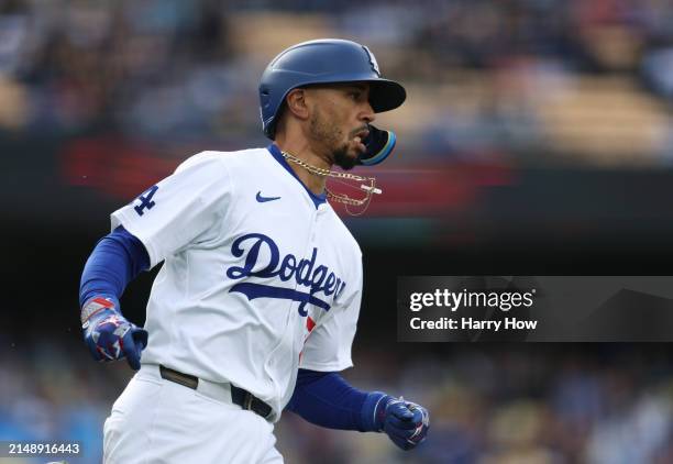 Mookie Betts of the Los Angeles Dodgers runs to first during a 6-3 loss to the San Diego Padres at Dodger Stadium on April 14, 2024 in Los Angeles,...