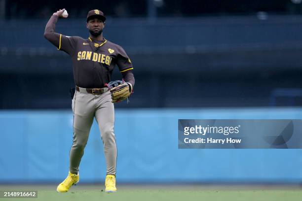 Jurickson Profar of the San Diego Padres warms up before the game against the Los Angeles Dodgers at Dodger Stadium on April 14, 2024 in Los Angeles,...