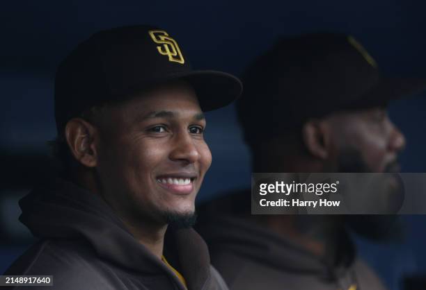 Jhony Brito of the San Diego Padres smiles in the dugout before the game against the Los Angeles Dodgers at Dodger Stadium on April 14, 2024 in Los...