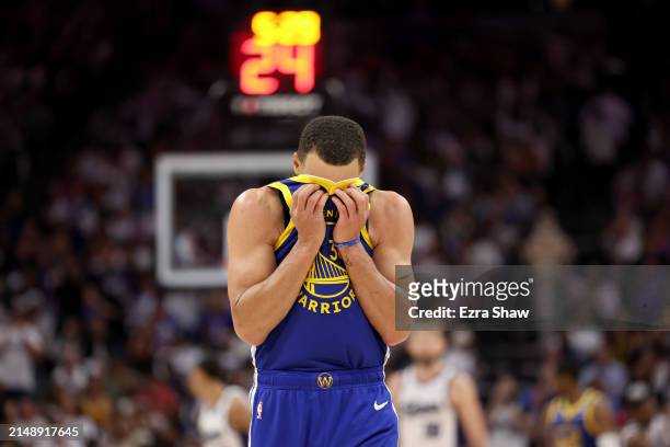 Stephen Curry of the Golden State Warriors wipes his face during the end of the the second half of their loss to the Sacramento Kings during the...