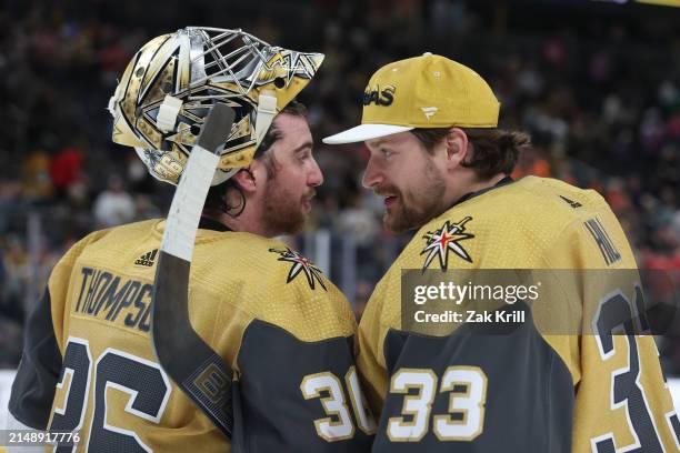 Logan Thompson of the Vegas Golden Knights celebrates with Adin Hill after a 3-1 victory against the Chicago Blackhawks at T-Mobile Arena on April...