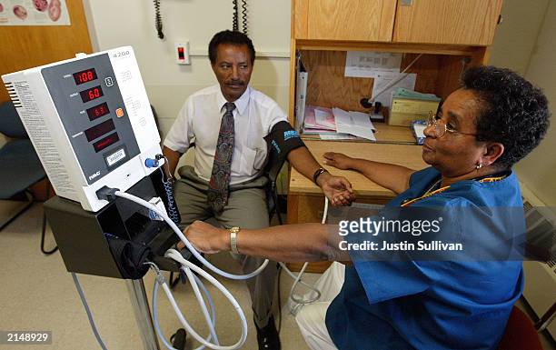 Nurse Melba Benedict checks Negash Berhe's blood pressure July 9, 2003 at Highland Hospital in Oakland, California. In a report released July 9,...