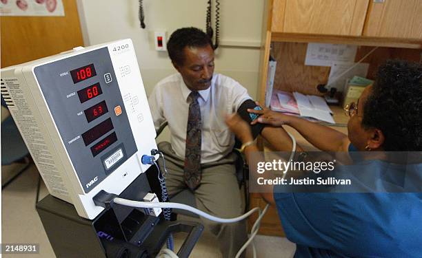 Nurse Melba Benedict checks Negash Berhe's blood pressure July 9, 2003 at Highland Hospital in Oakland, California. In a report released July 9,...