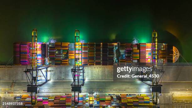aerial top view on cargo crane container terminal at night. - hamburger hafen stock-fotos und bilder