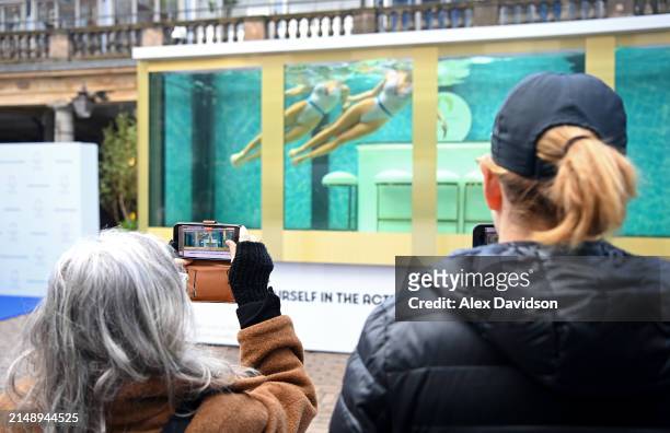 Members of the public and media attend the synchronized swimming event by On Location celebrating 100 days until the Paris 2024 Olympic Games on...