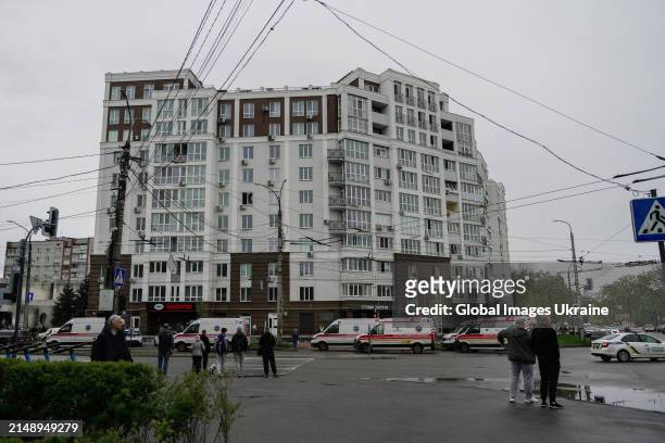 Local residents stand opposite to ambulances near residential building damaged as result of missile attack on April 17, 2024 in Chernihiv, Ukraine....