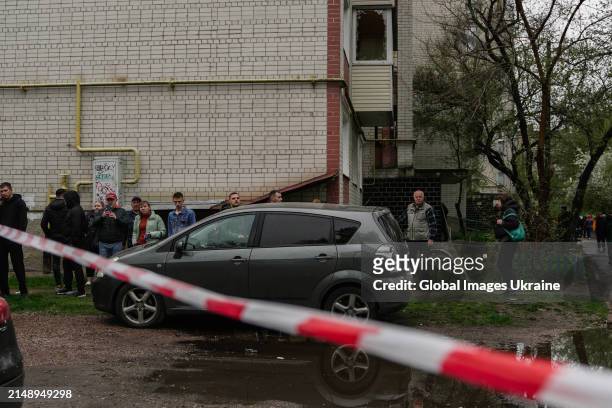 Local residents stand in the yard of residential building damaged as result of missile attack on April 17, 2024 in Chernihiv, Ukraine. Russian forces...