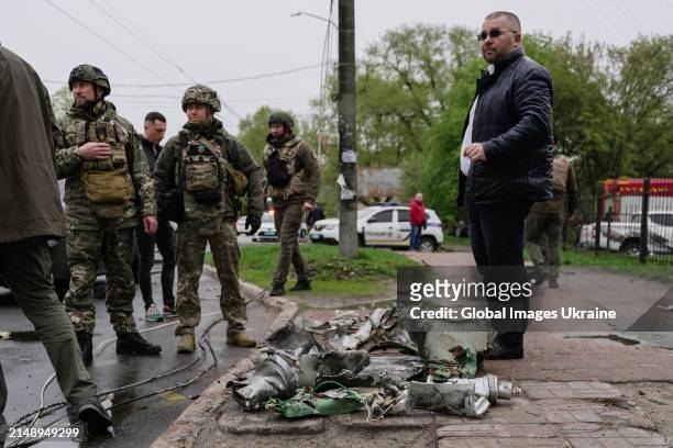 Military members stand near collected remains of missile which fall at residential district on April 17, 2024 in Chernihiv, Ukraine. Russian forces...