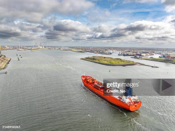 tanker ship entering the port of ijmuiden seen from above. - canal stock pictures, royalty-free photos & images