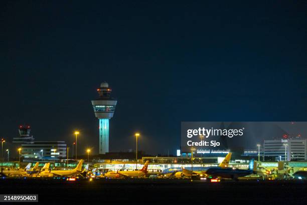 schiphol amsterdam airport at night - amsterdam airport stock pictures, royalty-free photos & images