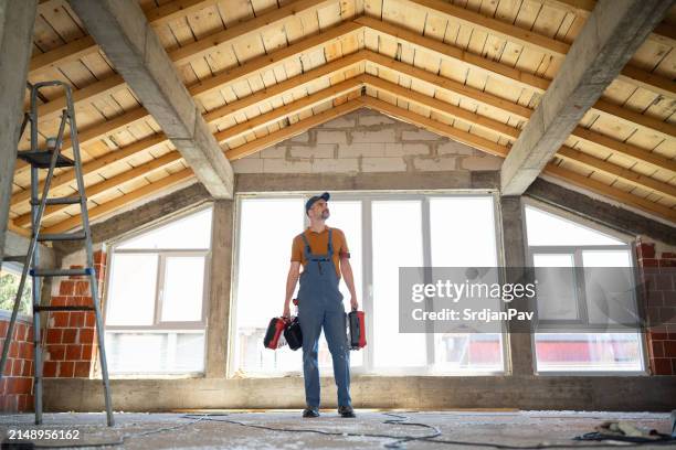 confident construction worker at job site - attic stock pictures, royalty-free photos & images