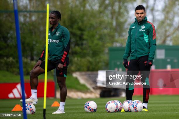 Habeeb Ogunneye and Casemiro of Manchester United in action during a first team training session at Carrington Training Ground on April 16, 2024 in...