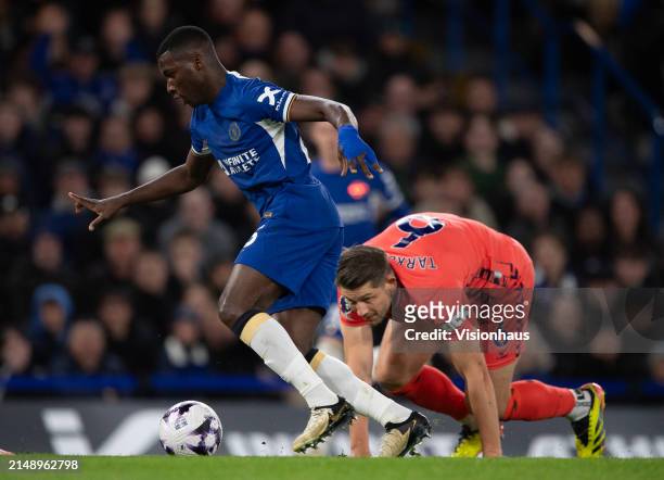 Moises Caicedo of Chelsea skips past James Tarkowski of Everton during the Premier League match between Chelsea FC and Everton FC at Stamford Bridge...