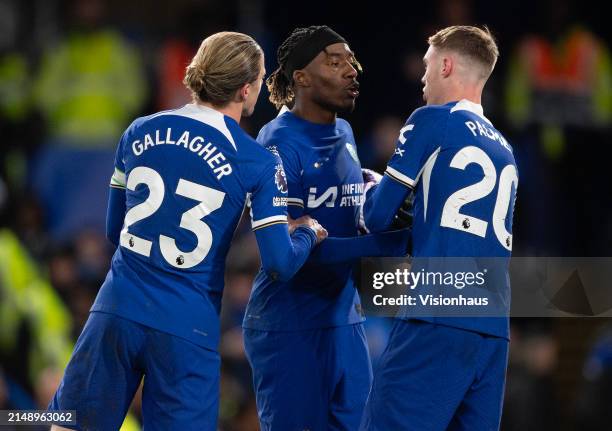 Noni Madueke of Chelsea argues with Cole Palmer over who takes the penalty as Conor Gallagher mediates during the Premier League match between...