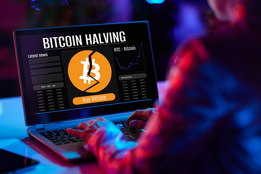Closeup on modern female with laptop and bitcoin halving screen