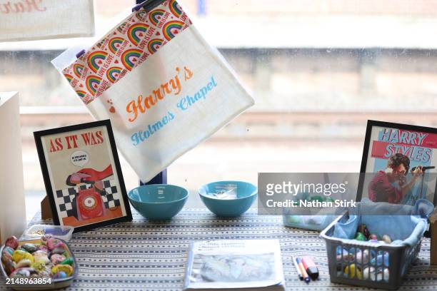 Harry Styles memorabilia is displayed at Holmes Chapel Train Station on April 17, 2024 in Holmes Chapel, England. The Holmes Chapel Partnership has...
