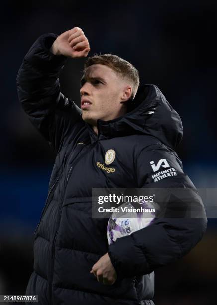 Cole Palmer of Chelsea claims the match ball after scoring four goals during the Premier League match between Chelsea FC and Everton FC at Stamford...