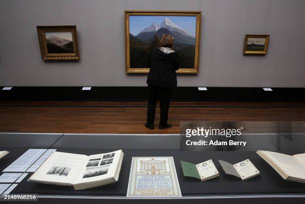 Program for the "Deutsche Jahrhundert Ausstellung Berlin 1906" is seen in front of the painting "Der Watzmann" or "The Watzmann" by Caspar David...