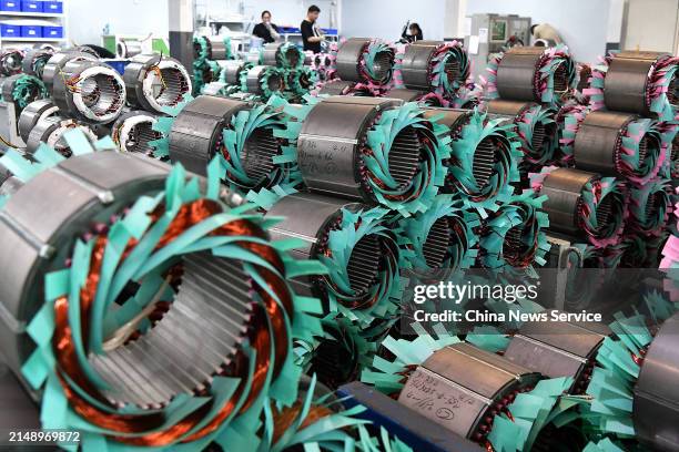 Employees work on the production line of electric motors at the workshop of Able Electric Motor Co., Ltd. On April 16, 2024 in Ningde, Fujian...