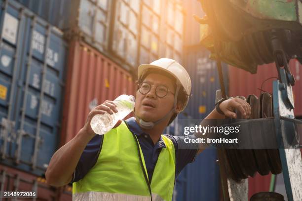 foreman is working at container yard while hot weather in summer season. - heatwave stock pictures, royalty-free photos & images