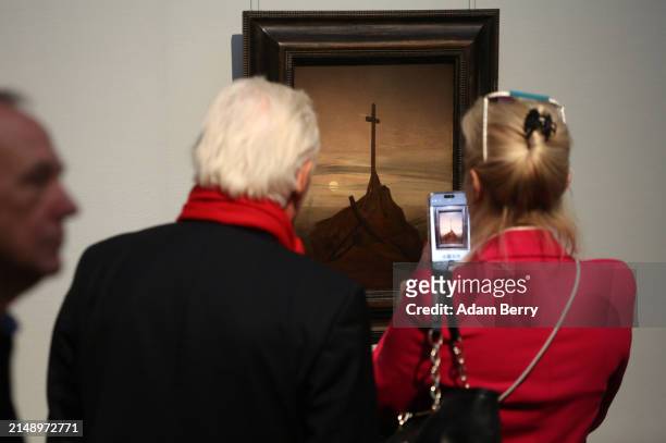 Painting labeled as a possible copy of Caspar David Friedrich's painting "Das Kreuz an der Ostsee" or "Cross on the Baltic," labeled as possibly...