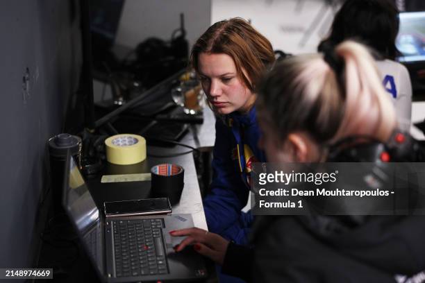 Emely de Heus of Netherlands and MP Motorsport studies data with MP Motorsport team members during F1 Academy Testing at Circuit Zandvoort on April...