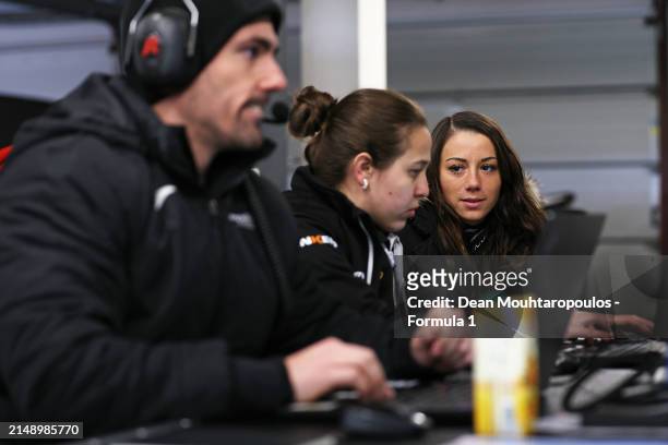Carrie Schreiner of Germany and Campos Racing talks with a Campos Racing team member in the garage during F1 Academy Testing at Circuit Zandvoort on...
