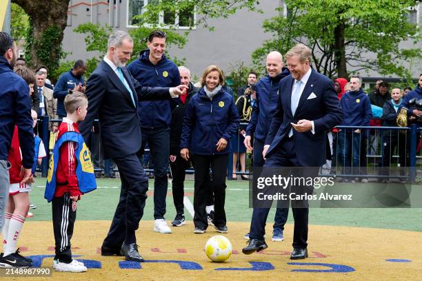 King Felipe VI of Spain and King Willem-Alexander of the Netherlands kick off the match during they visit to the Johan Cruyff Foundation for children...