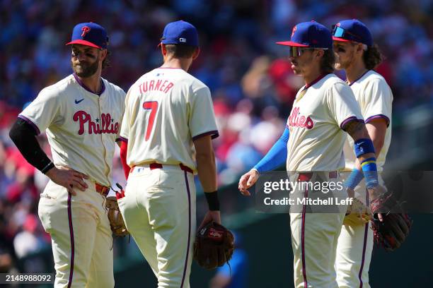 Bryce Harper, Trea Turner, Bryson Stott, Alec Bohm of the Philadelphia Phillies looks on against the Pittsburgh Pirates at Citizens Bank Park on...