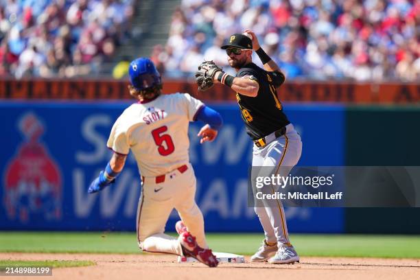 Jared Triolo of the Pittsburgh Pirates attempts to turn a double play against Bryson Stott of the Philadelphia Phillies at Citizens Bank Park on...