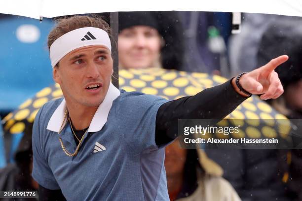 Alexander Zverev of Germany reacts as hi sit under a umbrella during a rain break at his second round match against Jurij Rodionov of Austria on day...