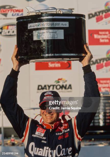 Dale Jarrett from the United States, driver of the Quality Care Service, Ford Credit Robert Yates Racing Ford Taurus raises the Harley J Earl Trophy...