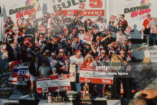 Dale Jarrett from the United States, driver of the Quality Care Service, Ford Credit Robert Yates Racing Ford Taurus celebrates with the team after...