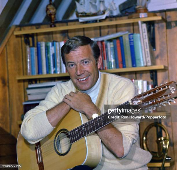 Irish singer Val Doonican posed with a Levin 12-string acoustic guitar in England circa 1970.