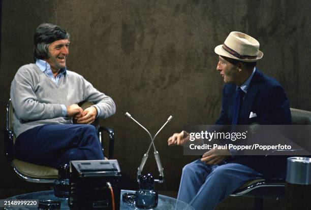 English television presenter and host Michael Parkinson interviews, on right, American singer and actor Bing Crosby on the set of a television chat...