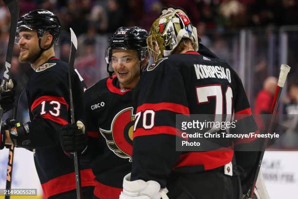 Joonas Korpisalo of the Ottawa Senators celebrates a 5-4 shootout win against the Montreal Canadiens with Erik Brannstrom at Canadian Tire Centre on...