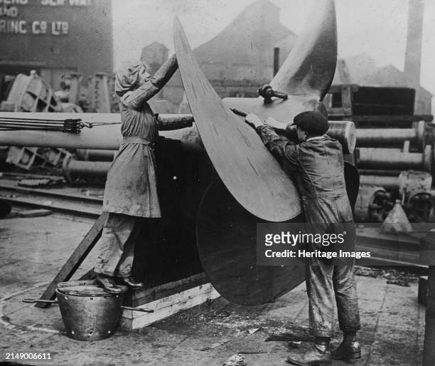 Women working on propeller, Eng. [i.e. England], between circa 1915 and 1917. Women working on a propeller in a navy shipbuilding yard in England...