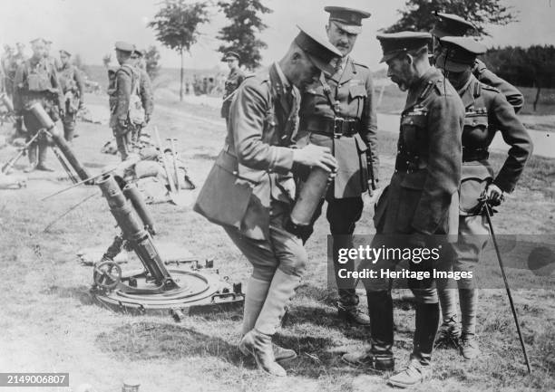 King Geo. Studies trench bombs, 7 Jul 1917. British officers explaining trench mortar to King George V and Edward, Prince of Wales at the Trench...